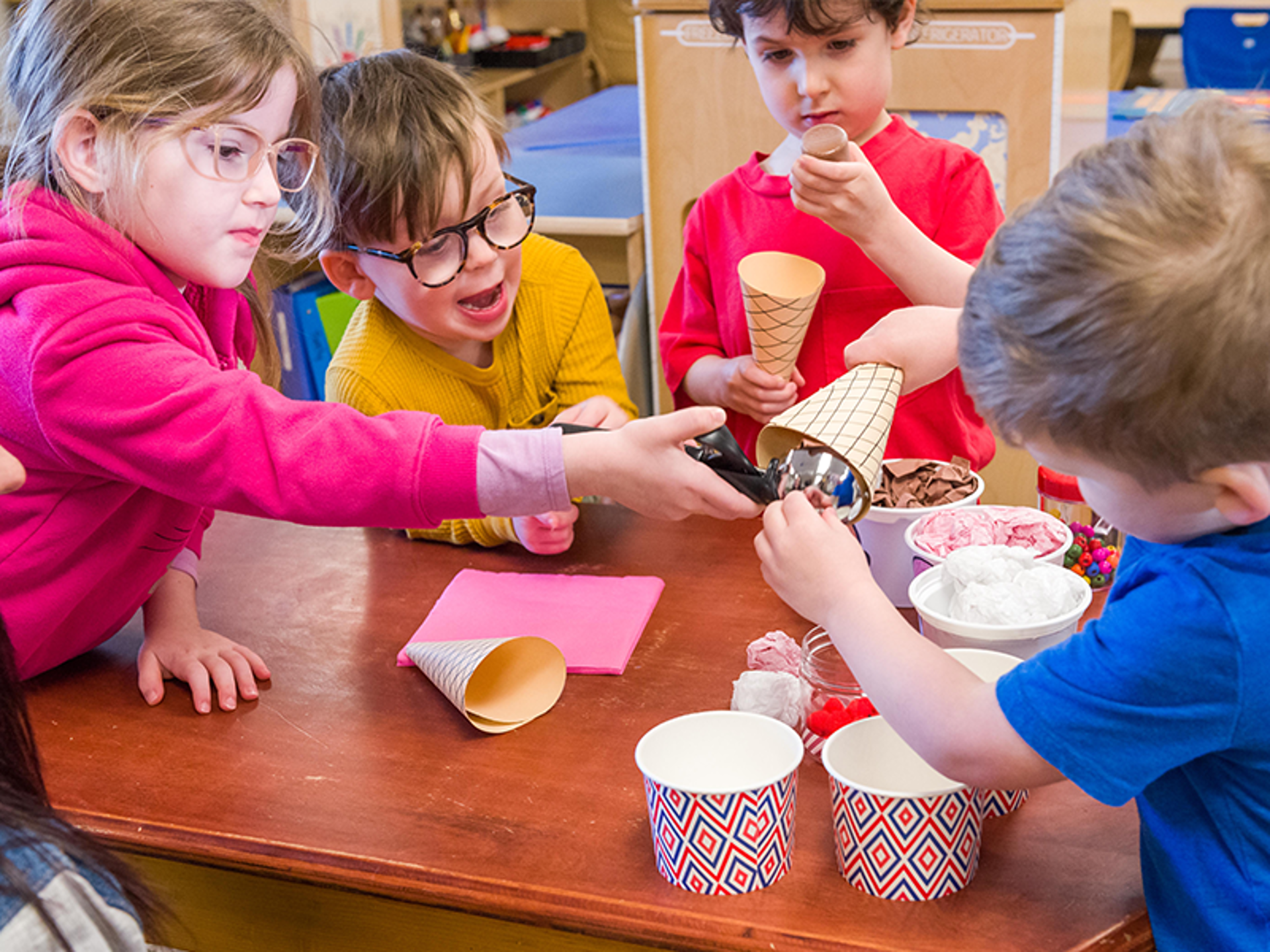 kids playing with a pretend play ice cream set