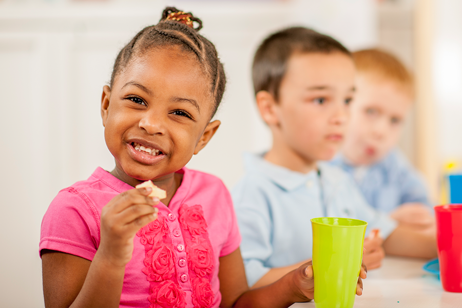 children sitting and eating a snack
